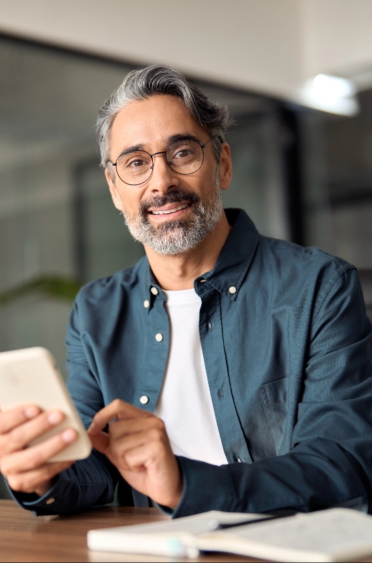 Man at office using cell phone