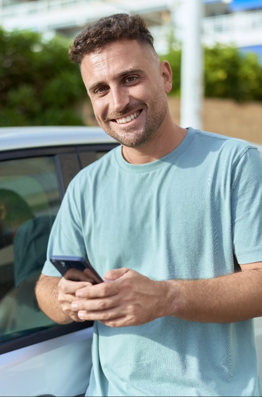 Man smiling and using cell phone