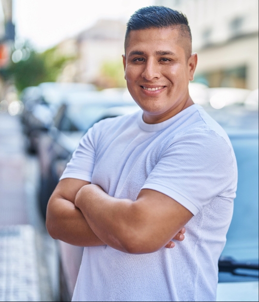 Man smiling for picture in street