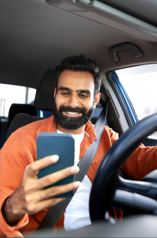 Middle aged man using phone when car is parked