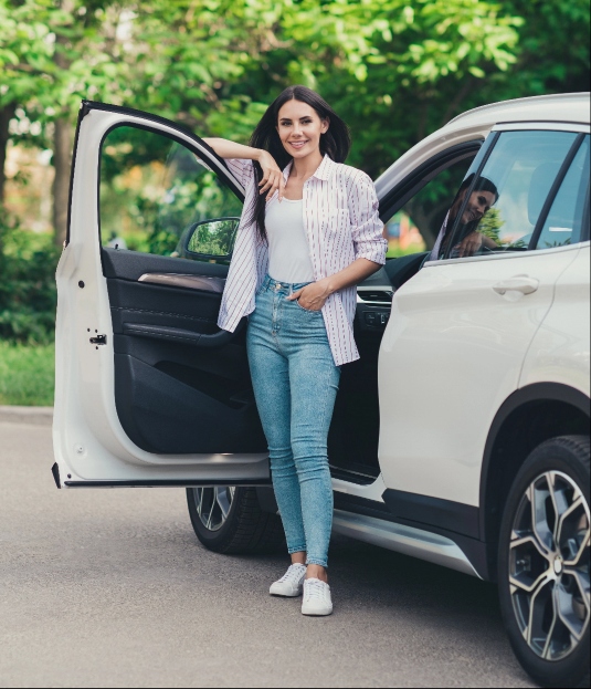 Woman standing outside car