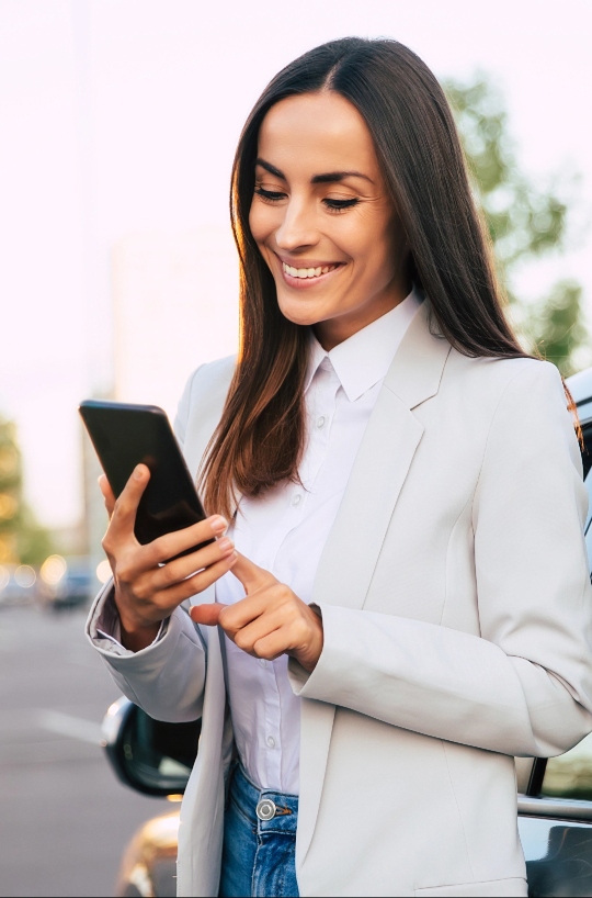 Woman using phone and smiling