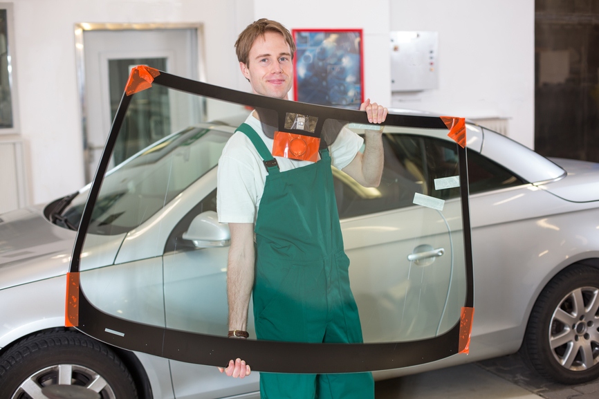 Man smiling replacing windshield