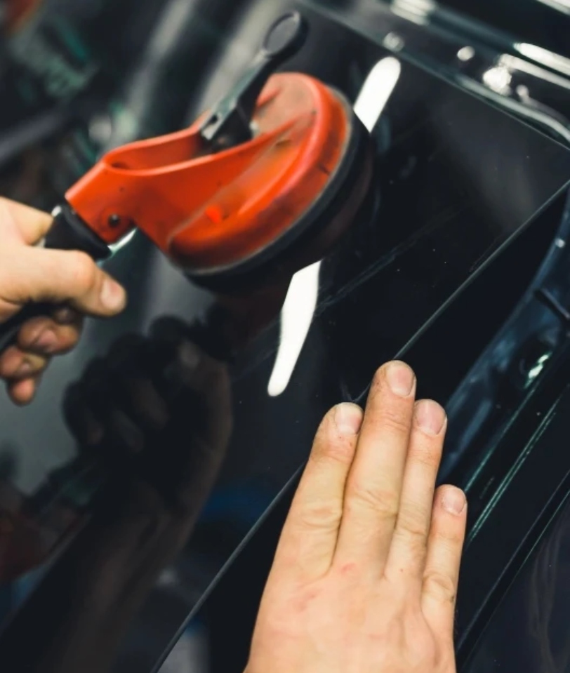 Man repairing back window vehicle